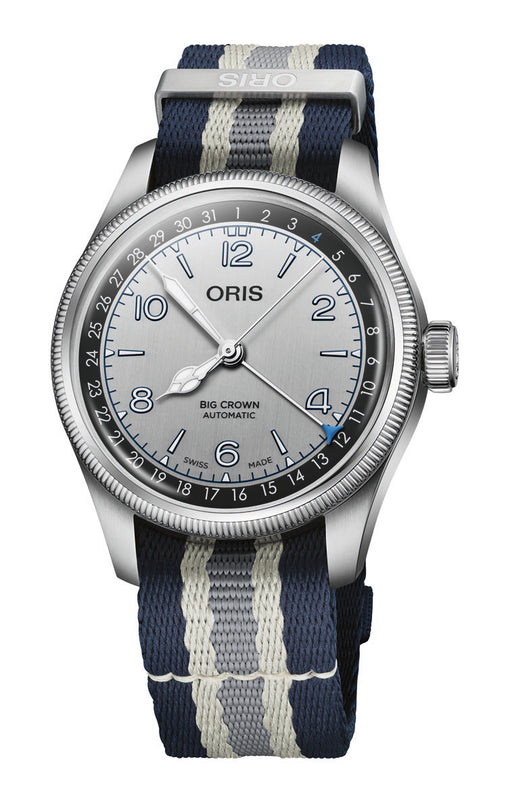 Oris Big Crown Automatic watch with silver dial, numbered bezel, and navy blue striped fabric strap.