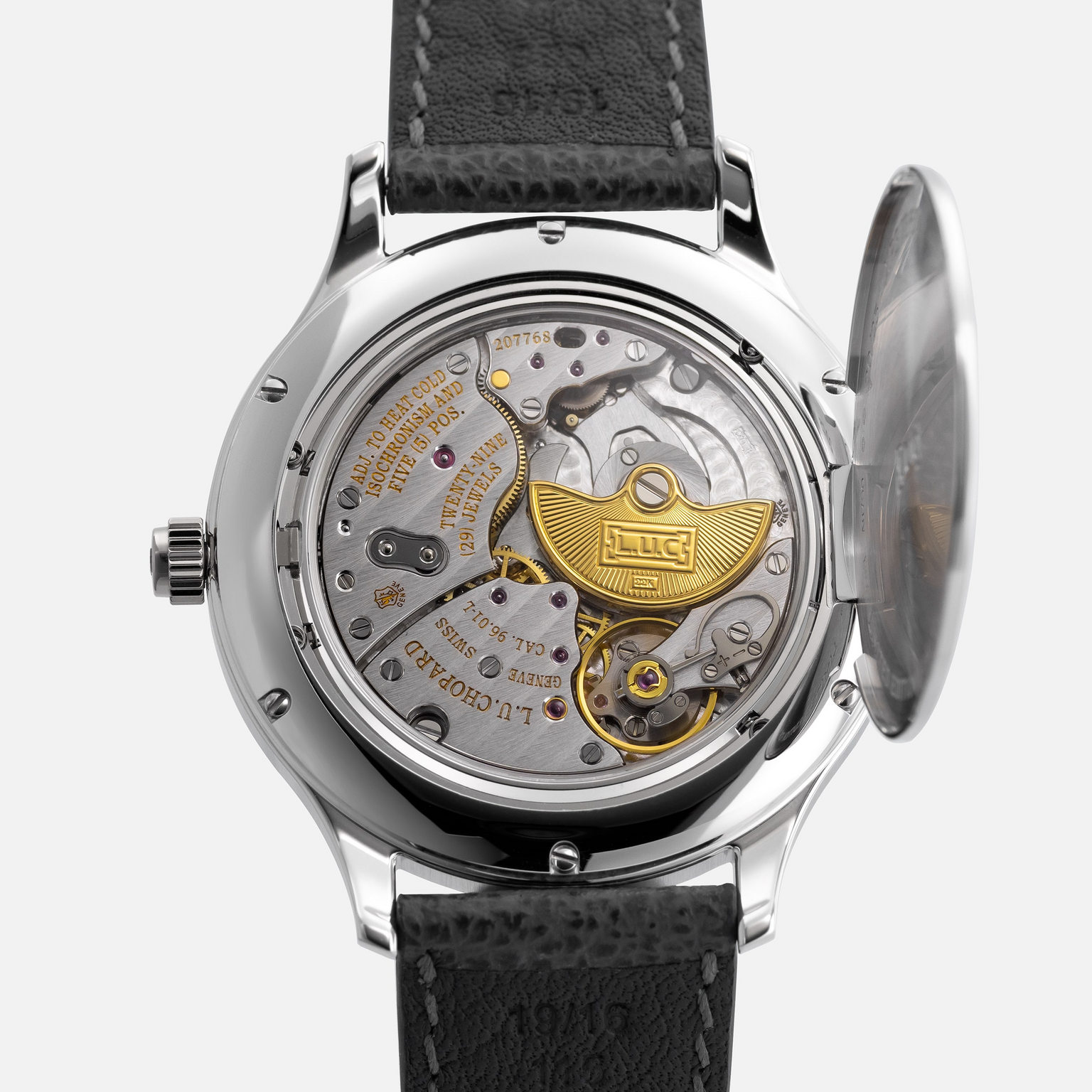 Close-up of the Chopard L.U.C XPS 1860 Officer Limited Edition For Hodinkee by Chopard, showcasing its detailed mechanical movement and gold rotor through the open case back, complemented by a black leather strap and refined white gold case.