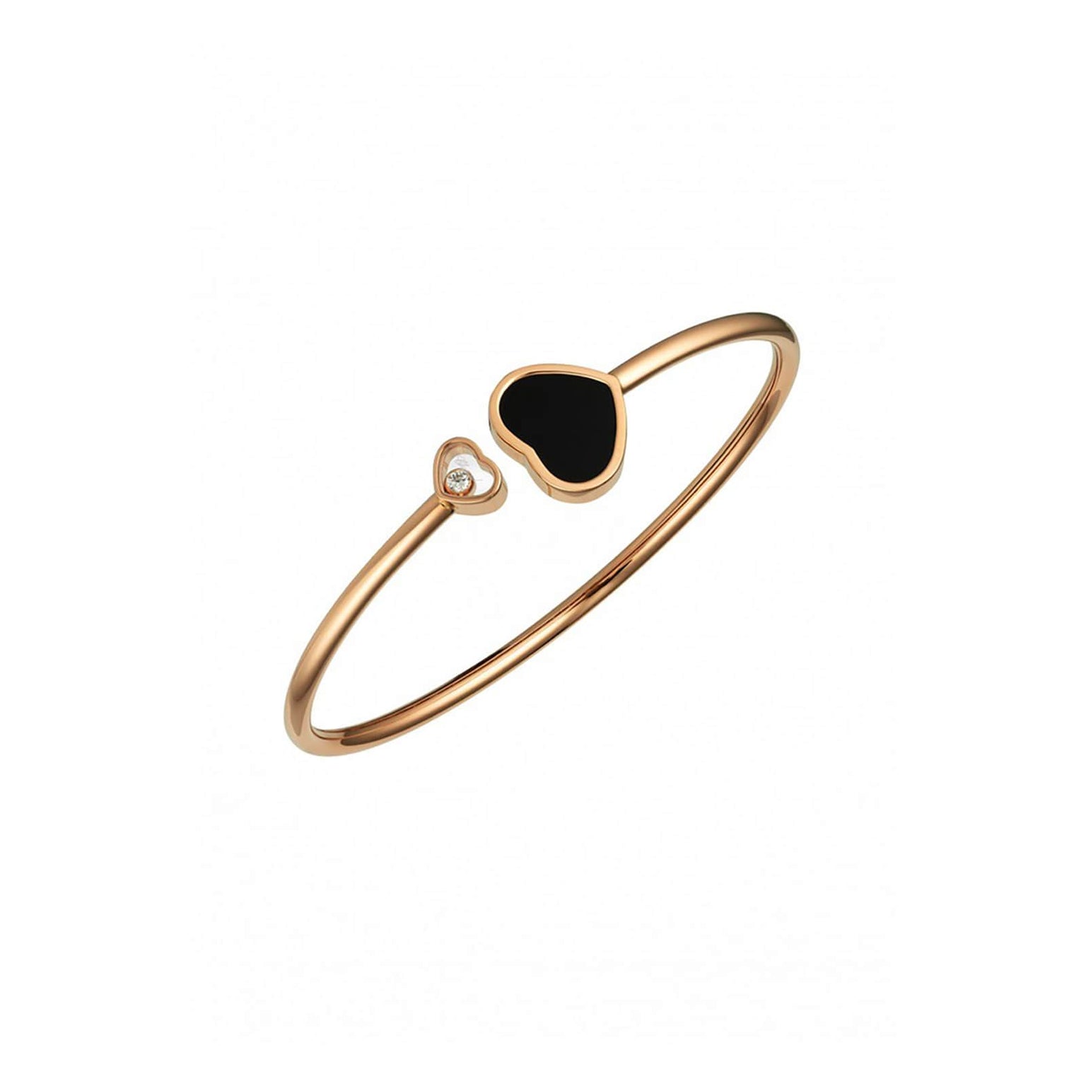 The Chopard Happy Hearts bangle in 18ct ethical rose gold features two heart ends—one with a black inlay and one with a sparkling moving diamond.