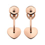 A pair of rose gold clip-on earrings from Chopard’s Happy Diamonds collection, featuring heart-shaped pendants hanging from curved bars.