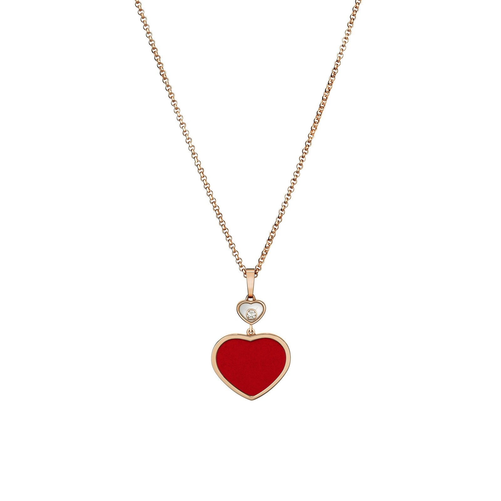 The Chopard Happy Hearts necklace features a red heart-shaped pendant in 18ct rose gold with a floating diamond above the heart.