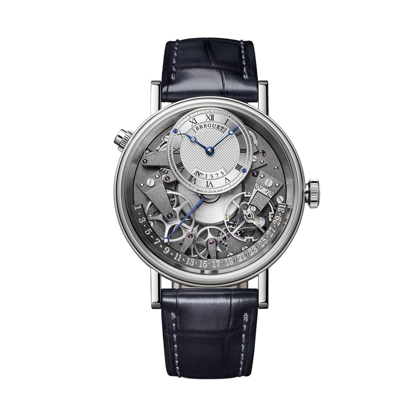 The Breguet Tradition Quantième Rétrograde 7597 is a luxury wristwatch with a visible mechanical movement, Roman numerals, blue hands, date indicator, and a black leather strap.