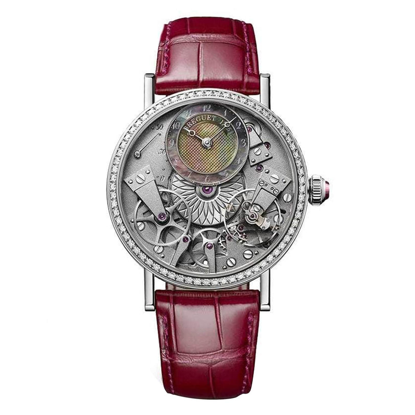 The Breguet Tradition 7038 is a luxury skeleton watch with a red leather strap, visible intricate gears, and a silver case adorned with diamond accents.