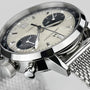 Close-up of the Hamilton American Classic Intra-Matic Auto Chrono featuring a stainless steel mesh bracelet, cream panda dial with black subdials, date display, and sleek stainless steel case.