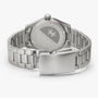 The Hamilton Khaki Field Quartz 33mm is shown from the back, highlighting its engraved stainless steel case and clasp.