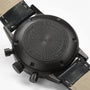 Back of a black Hamilton American Classic Intra-Matic Auto Chrono wristwatch with textured engraving and leather strap, displaying the brand and water resistance.