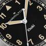 Close-up of the Hamilton Khaki Field Quartz 33mm watch face at 10:10:30, featuring beige hour markers and hands on a black dial—a durable, exploration-ready timepiece.
