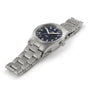 The Hamilton Khaki Field Quartz 33mm is a silver metal wristwatch with a linked band, black dial, and white Arabic numerals, showcased on a white background.