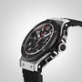 A close-up of the Hublot Big Bang Original Steel Ceramic wristwatch, featuring a black and silver case, textured band, detailed analog face with multiple dials and red accents in an automatic chronograph design.