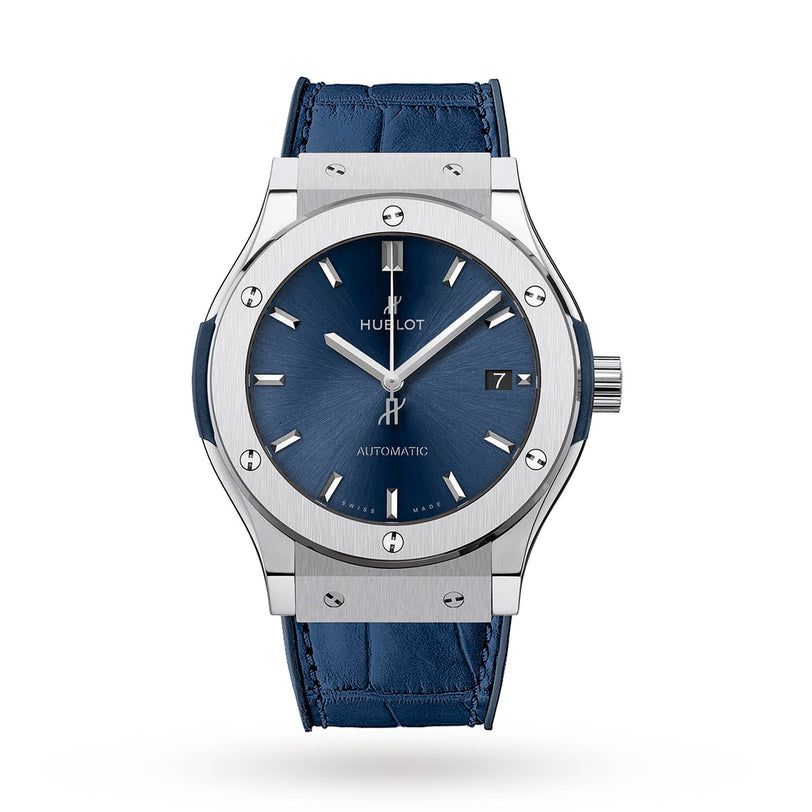 The Hublot Classic Fusion Titanium Blue features a blue sunray dial with silver markers, date display, and a blue leather strap in a titanium case, shown on a white background.