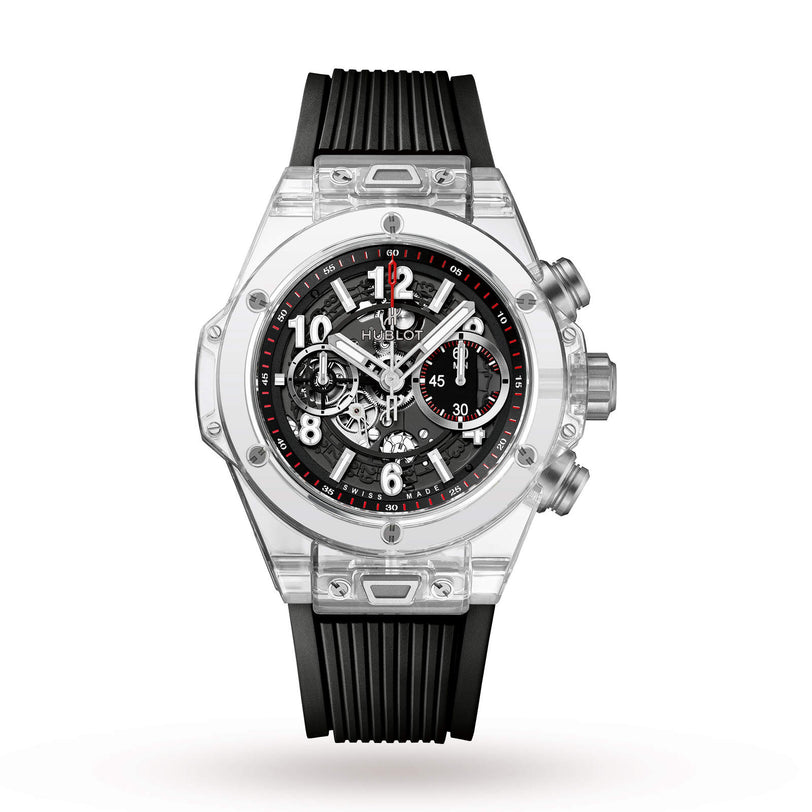 The Hublot Big Bang Unico Sapphire features a transparent case, black rubber strap, visible chronograph movement with three subdials, and silver push buttons on the right side.