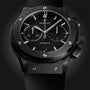 A close-up of the Hublot Classic Fusion Chronograph Black Magic watch featuring a black dial, silver hour markers, subdials, black strap, and a sleek black ceramic case.