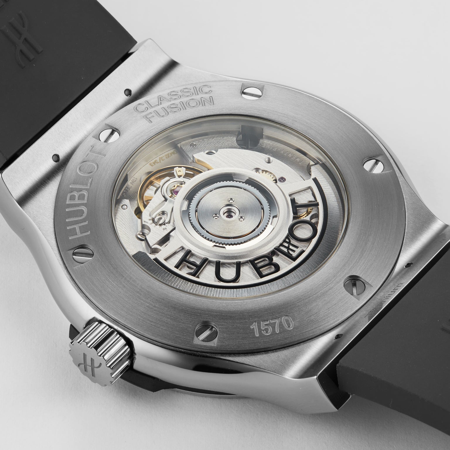 Close-up of the Hublot Classic Fusion Racing Grey Titanium, showcasing its exposed automatic movement through a transparent caseback and highlighting its sleek titanium construction.