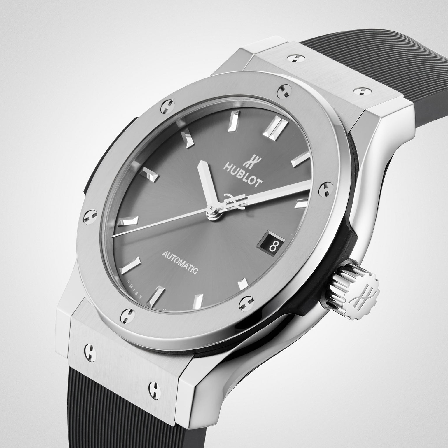A close-up of the Hublot Classic Fusion Racing Grey Titanium, featuring a titanium case, racing grey sunray dial, black rubber strap, and a date display at 3 o’clock.