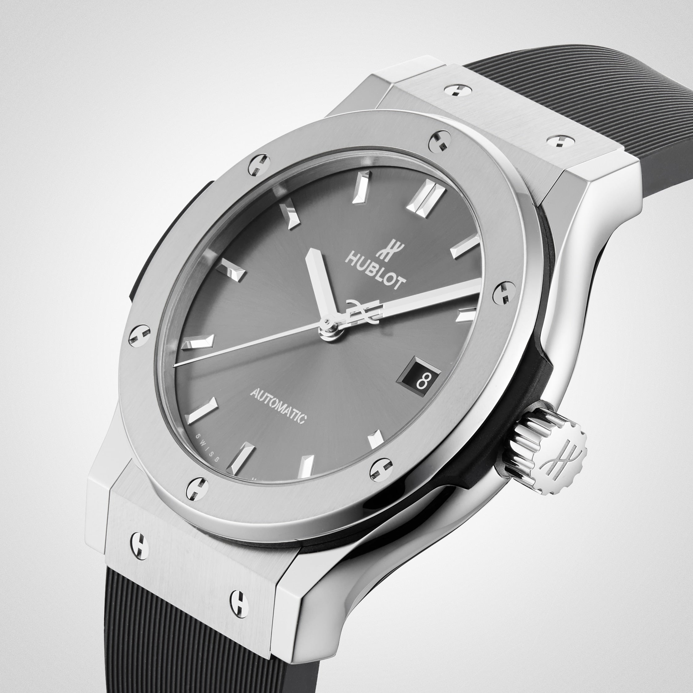 A close-up of the Hublot Classic Fusion Racing Grey Titanium, featuring a titanium case, racing grey sunray dial, black rubber strap, and a date display at 3 o’clock.