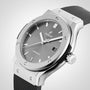 A close-up of the Hublot Classic Fusion Racing Grey Titanium, featuring a titanium case, racing grey sunray dial, black rubber strap, and a date display at 3 o’clock.