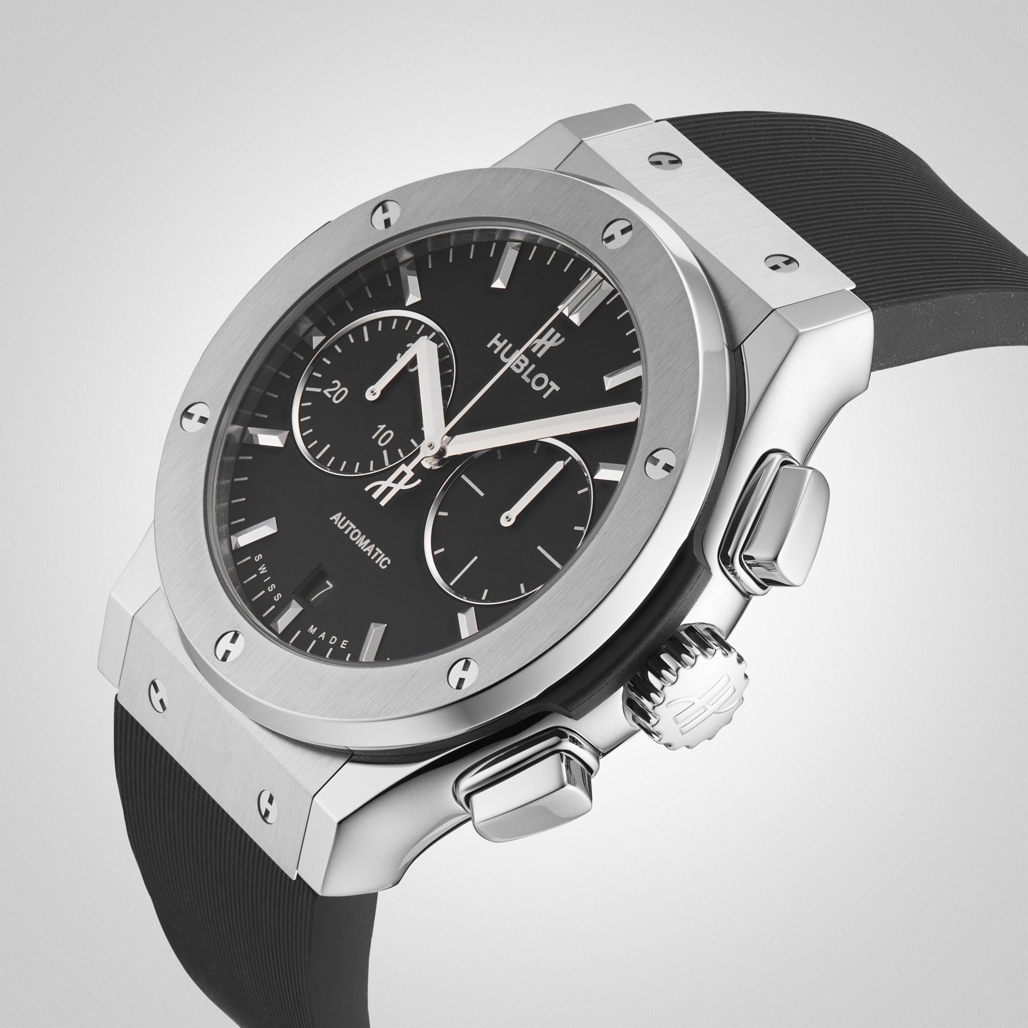 The Hublot Classic Fusion Chronograph Titanium wristwatch features a titanium case, black dial with two subdials, silver hour markers, and a black rubber strap, displayed against a plain light background.