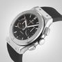 The Hublot Classic Fusion Chronograph Titanium wristwatch features a titanium case, black dial with two subdials, silver hour markers, and a black rubber strap, displayed against a plain light background.