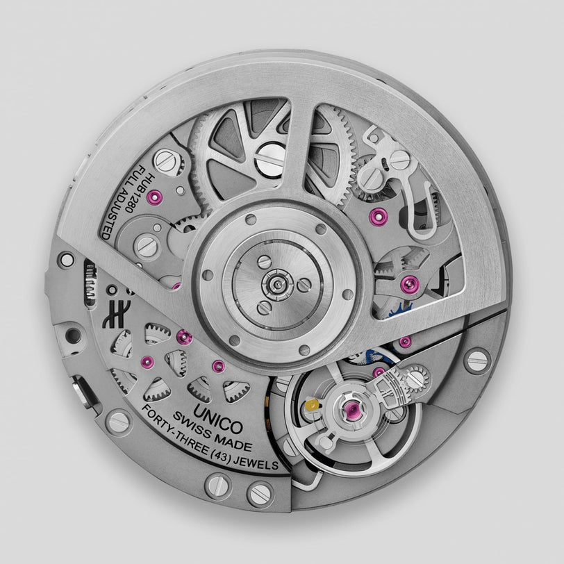 Close-up of the Hublot Square Bang Unico Titanium’s mechanical movement, showcasing visible gears, jewels, SWISS MADE and FORTY-THREE (43) JEWELS engraving, all in a sleek titanium case inspired by the Square Bang with advanced Unico movement.