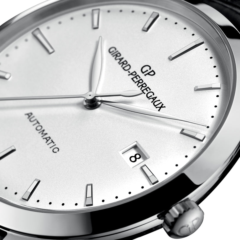Close-up of the Girard-Perregaux 1966 40 automatic watch, featuring a white dial, black hour markers, stainless steel case, and a date window showing the number 8.