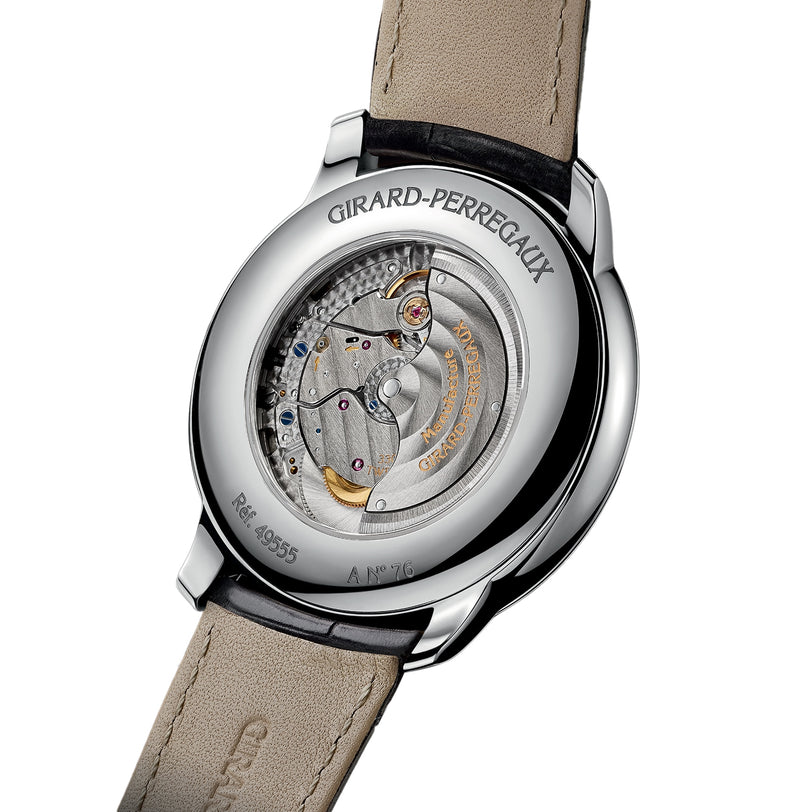 Close-up of the Girard-Perregaux 1966 40, showcasing its exceptional automatic movement and engravings through a transparent case back in polished stainless steel.