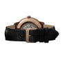 Rear view of the Girard-Perregaux 1966 40: a luxury wristwatch with a pink gold case, open caseback revealing the movement, and a black leather strap with a gold buckle.