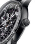 Close-up of the Girard-Perregaux Neo Bridges luxury skeleton watch, showcasing visible internal gears and a crown engraved with GP.