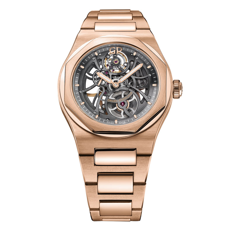 The Girard-Perregaux Laureato Skeleton, featuring a pink gold case, octagonal bezel, and visible mechanical movement on a metal link bracelet, is elegantly displayed against a white background.