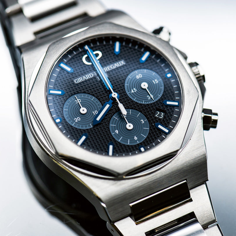 The Girard-Perregaux Laureato Chronograph 42 is crafted from 904L stainless steel and features an octagonal bezel, blue textured dial with three subdials, a date window, and luminescent hands and hour markers.