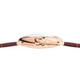 Side view of the Cartier Ballon Bleu de Cartier watch featuring a pink gold case, blue crown, guilloché dial, and brown leather strap.