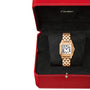 A rose gold Cartier Panthère de Cartier watch with a rectangular face, Roman numerals, and blue sapphire crown is displayed in an open red box with a black interior.