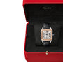 A Cartier Ballon Bleu de Cartier watch with a round face and black leather strap is elegantly displayed in an open red Cartier box.