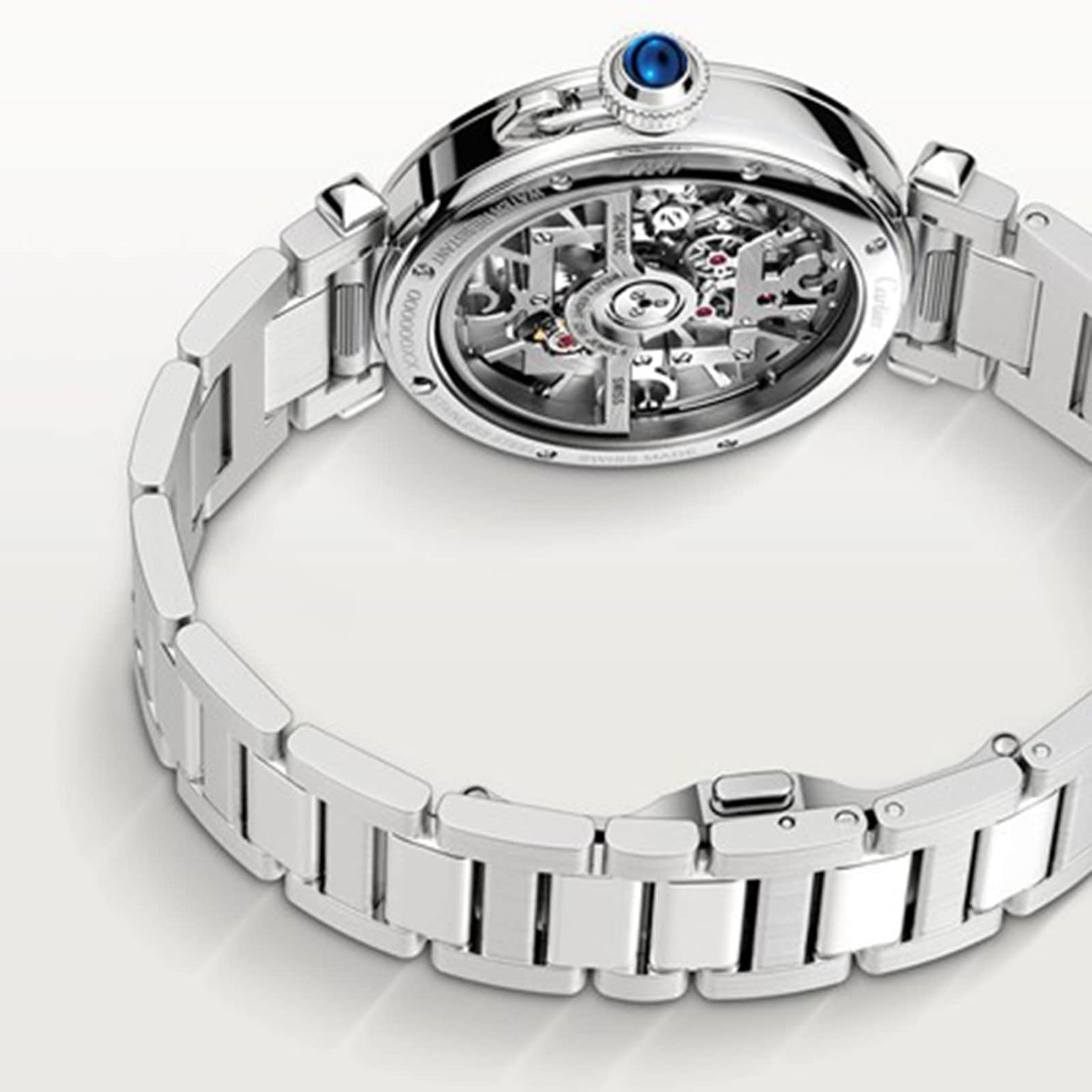 A Cartier Pasha de Cartier Skeleton watch is shown with its caseback up, exposing the intricate skeleton movement and detailed inner gears.