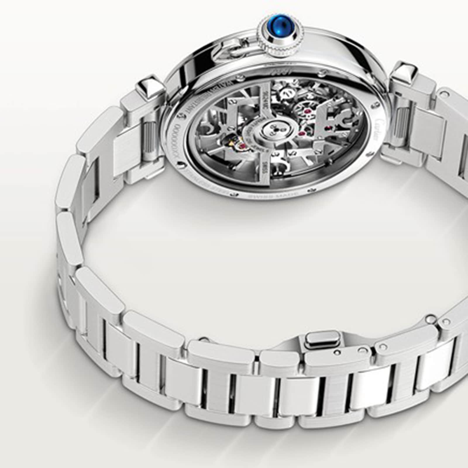 A Cartier Pasha de Cartier Skeleton watch is shown with its caseback up, exposing the intricate skeleton movement and detailed inner gears.