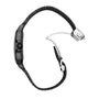 A side-profile view of the black Santos de Cartier watch by Cartier is shown against a white background, displaying its leather band, stainless steel deployment clasp, and QuickSwitch interchangeability system.