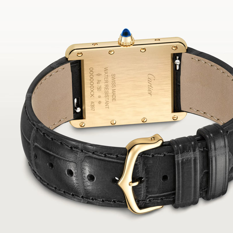 A close-up of the back of the Cartier Tank Louis Medium Model shows its gold case, matching buckle, black leather strap, engraved details, and iconic blue cabochon crown—reflecting the legacy of Louis Cartier in modern watchmaking.