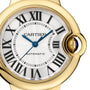 Close-up of the Cartier Ballon Bleu de Cartier watch featuring an automatic movement, yellow gold bracelet, Roman numeral markers, blue hands, and a sapphire cabochon crown.
