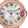 Close-up of the Cartier Ballon Bleu de Cartier watch in rose gold, showcasing a round diamond-set bezel, Roman numerals, blue hands, automatic movement, and a blue cabochon crown. The dial reads CARTIER and AUTOMATIC.