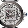 Close-up of the Cartier Pasha de Cartier Skeleton watch, highlighting its intricate skeleton design with exposed gears, refined metalwork, and signature blue cabochon crown that displays its remarkable mechanical movement.