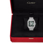 A Santos de Cartier Skeleton wristwatch by Cartier is displayed in a black velvet interior of a red Cartier box.