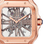 Close-up of the Santos de Cartier Skeleton watch by Cartier, featuring a rose gold case, visible gears, and Roman numeral hour markers seamlessly integrated into its openwork dial.