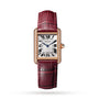 The Cartier Tank Louis Cartier watch features a rectangular rose gold case, diamond bezel, white dial with Roman numerals, blue hands, and a burgundy leather strap.