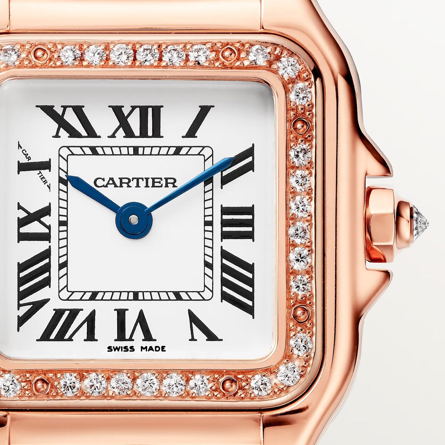 Close-up of the Panthère de Cartier Small Model by Cartier, featuring a square face, Roman numerals, blue hands, rose gold case, and a diamond-set bezel.