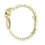 The La Panthère de Cartier by Cartier is a gold luxury watch bracelet with a leopard head featuring green eyes and black spots, a curved band for elegance, and a partially visible watch face for added allure.