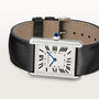 A Cartier Tank Must de Cartier watch with a square face, Roman numerals, blue sword-shaped hands, quartz movement, and a black leather strap is displayed on a light background.