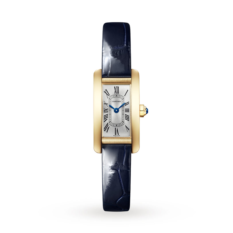 The Cartier Tank Américaine features a luxurious gold rectangular case, white dial with black Roman numerals, blue hands, and a dark blue leather strap—a true timeless classic.