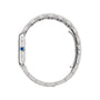 Side view of a Cartier Tank Must de Cartier watch with quartz movement, silver metal bracelet, and a round blue gem on the crown, displayed against a plain white background.