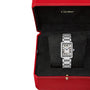 The Cartier Tank Must de Cartier features a rectangular silvered dial with Roman numerals, elegantly presented in a black velvet-lined red Cartier box.