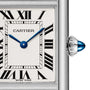 Close-up of the Cartier Tank Must de Cartier watch face with Roman numerals, blue steel hands, and a silver beaded crown set with a blue cabochon, featuring precise quartz movement.