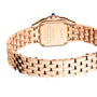 A Cartier Panthère de Cartier Small Model watch in rose gold is shown from the back, revealing its engraved case back, metal link bracelet, and iconic blue sapphire-set crown.